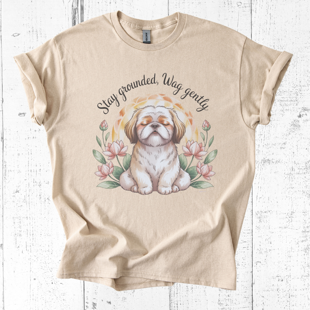 Beige t-shirt with a dog illustration and text on a wooden surface