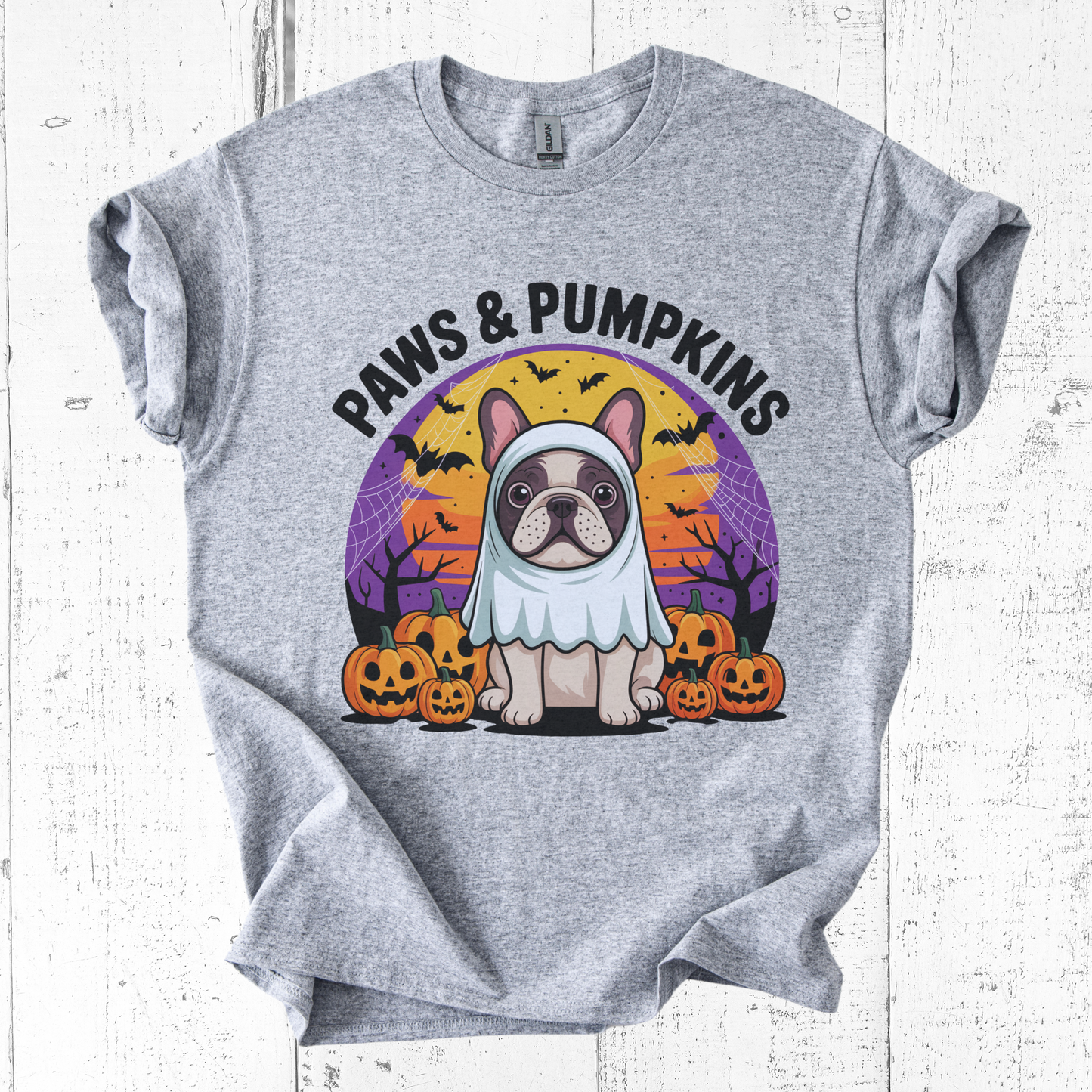 Gray t-shirt with a Halloween-themed design featuring a dog in a costume and pumpkins on a white wooden background.