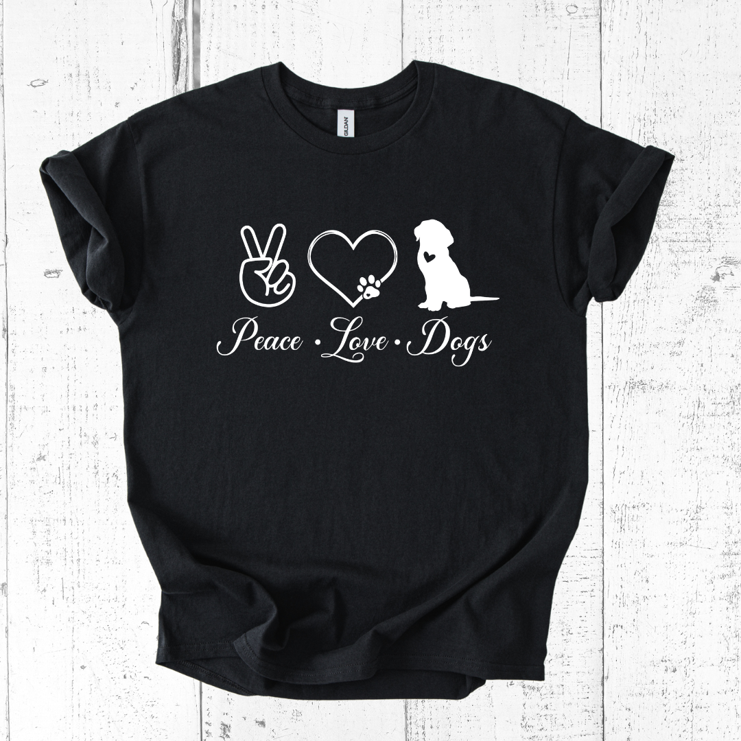 Black t-shirt with 'Peace Love Dogs' text and graphics on a white wooden background