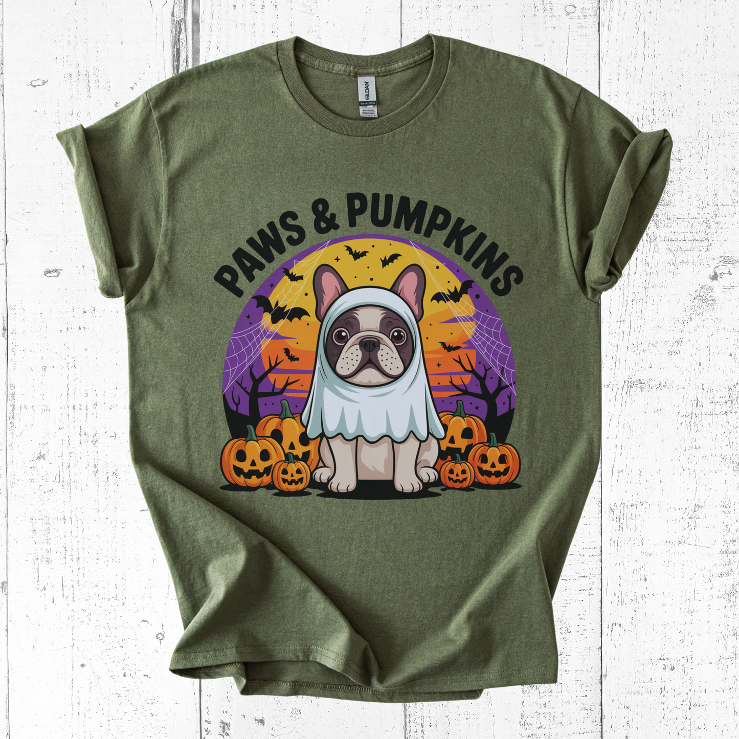 Green t-shirt with a dog in a costume graphic and 'Paws & Pumpkins' text on a white wooden background