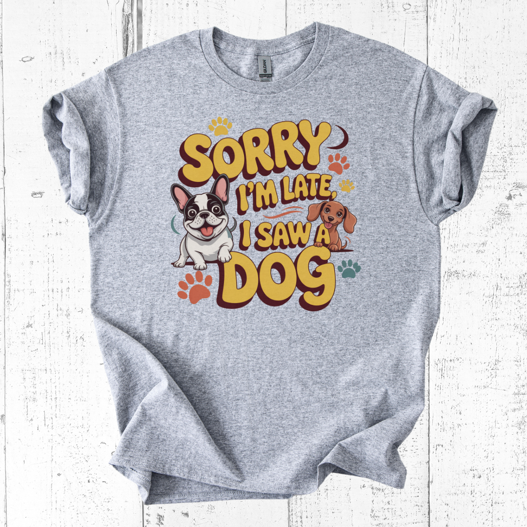 Gray t-shirt with 'Sorry I'm Late, I Saw a Dog' graphic on a white wooden background