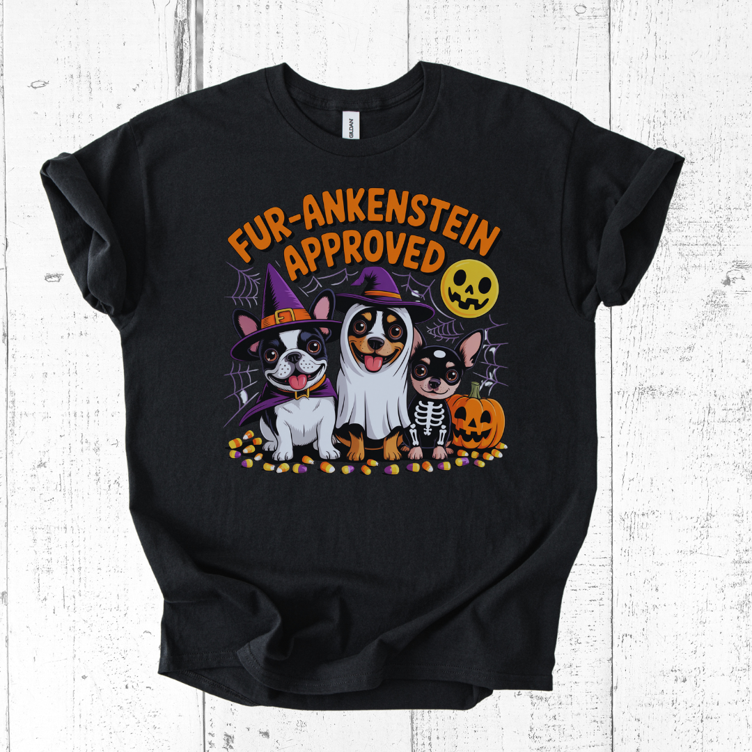 Black t-shirt with Halloween-themed design featuring dogs in costumes on a white wooden background.