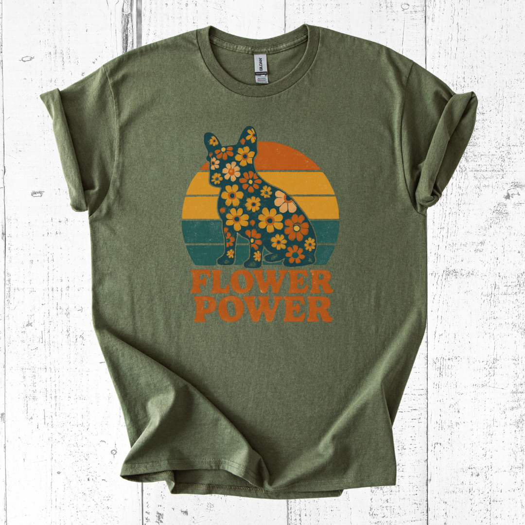 Green t-shirt with a bear and flower design on a white wooden background