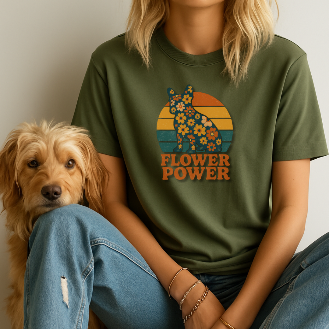 Person wearing a green t-shirt with a floral bear design and 'Flower Power' text, sitting next to a dog.