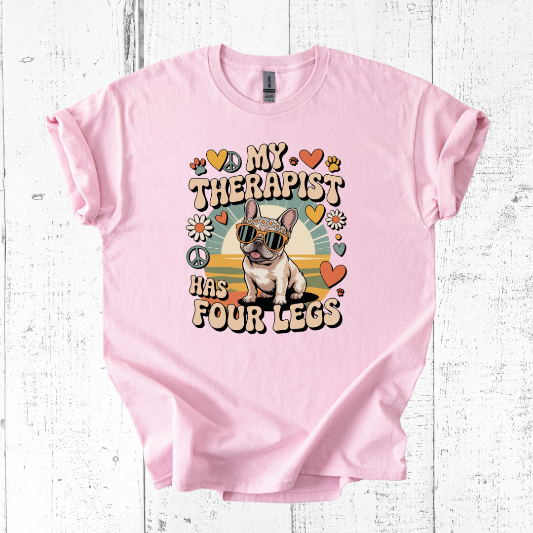 Pink t-shirt with a dog graphic and text on a white wooden background