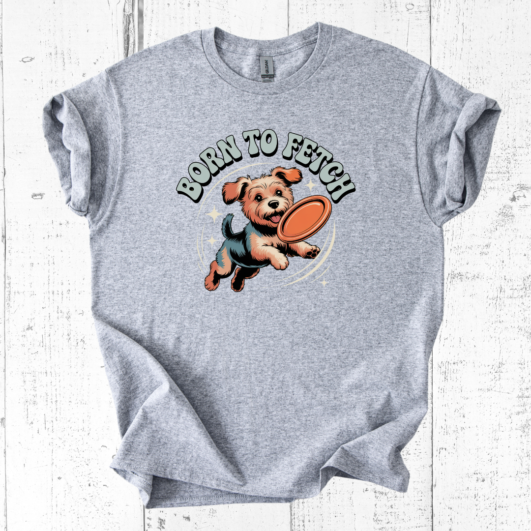 Gray t-shirt with a dog graphic and 'Born to Fetch' text on a white wooden surface