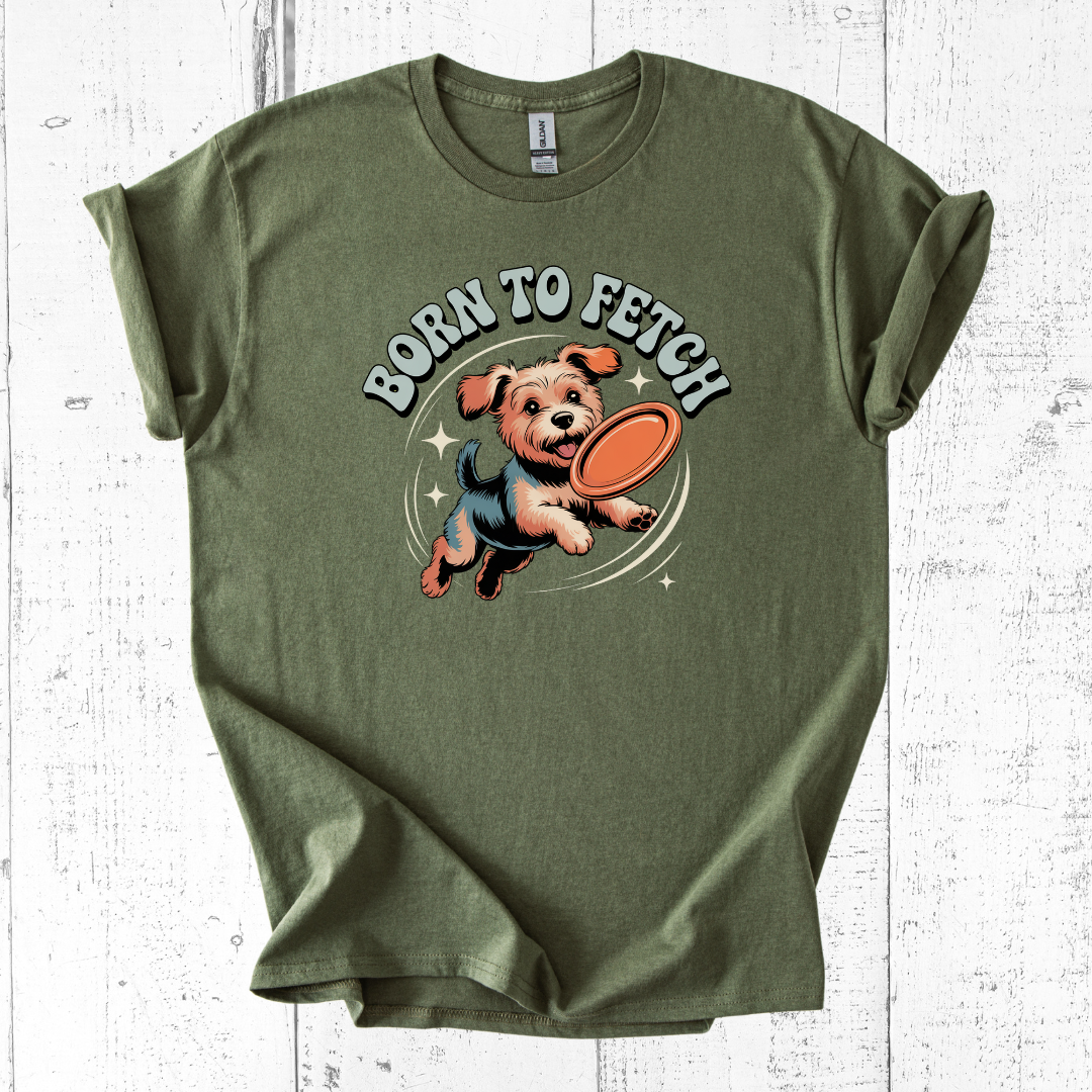 Green t-shirt with a dog graphic and 'Born to Fetch' text on a white wooden background