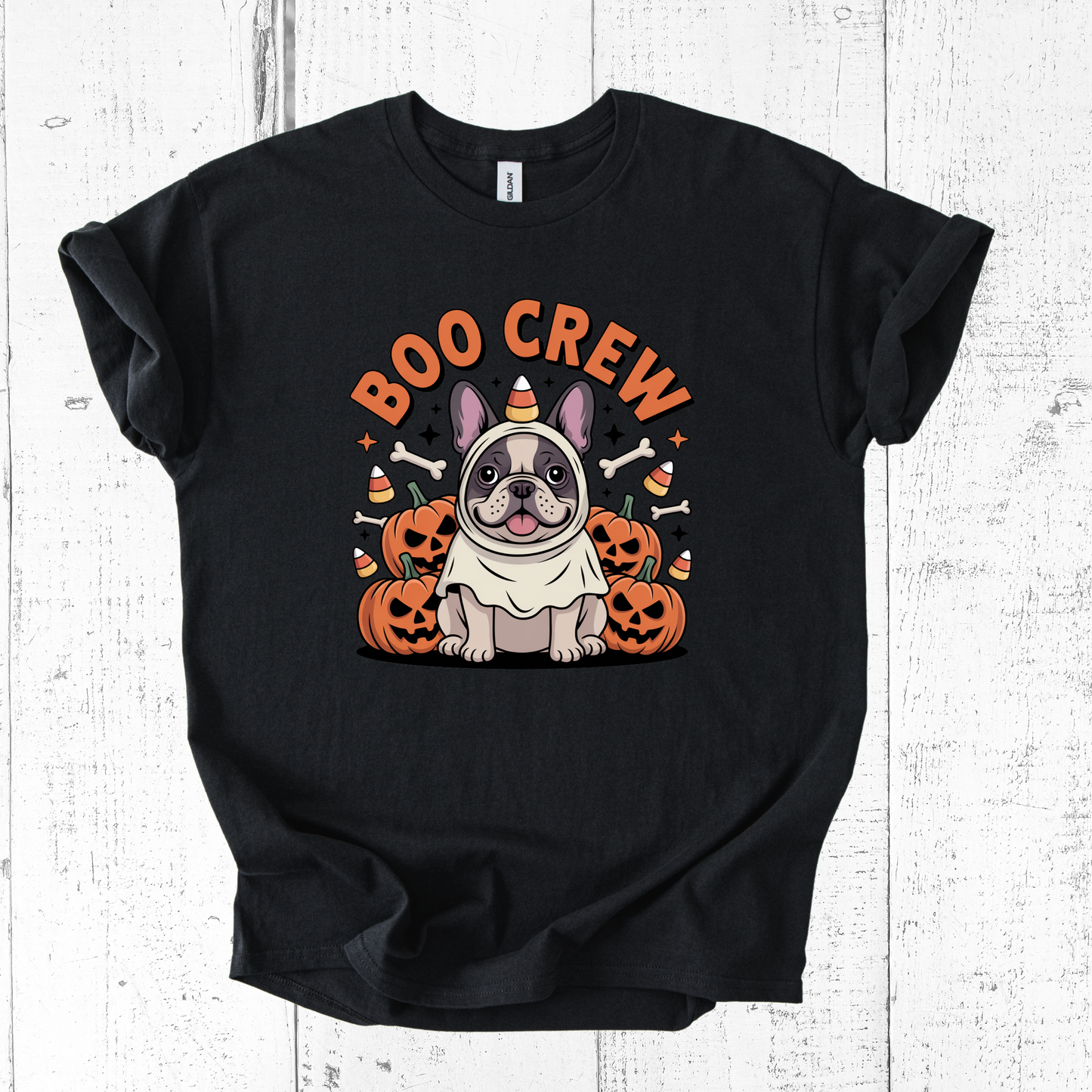 Black t-shirt with Halloween-themed design featuring a dog and 'BOO CREW' text on a white wooden background.