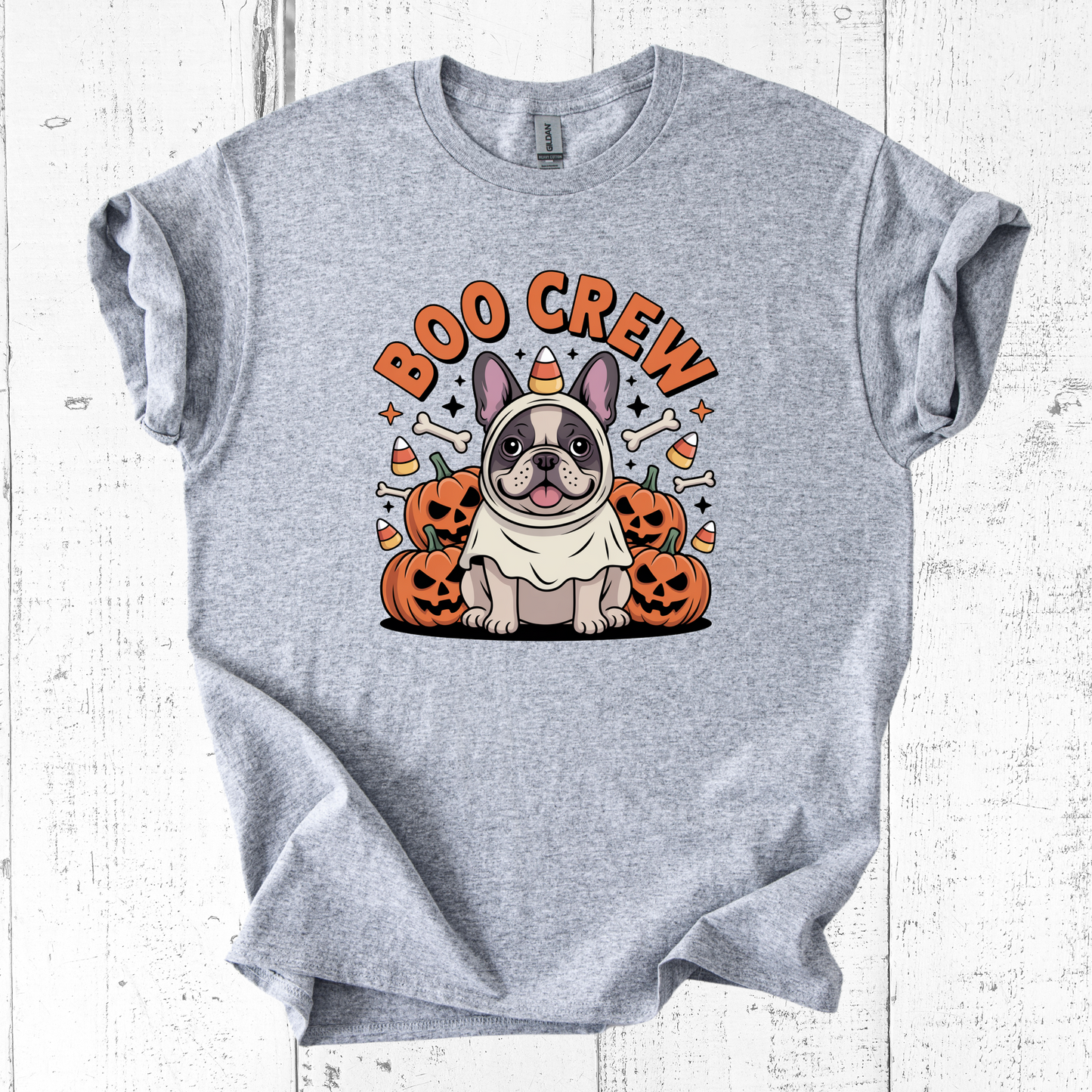 Gray t-shirt with a Halloween-themed design featuring a dog and pumpkins on a white wooden background.