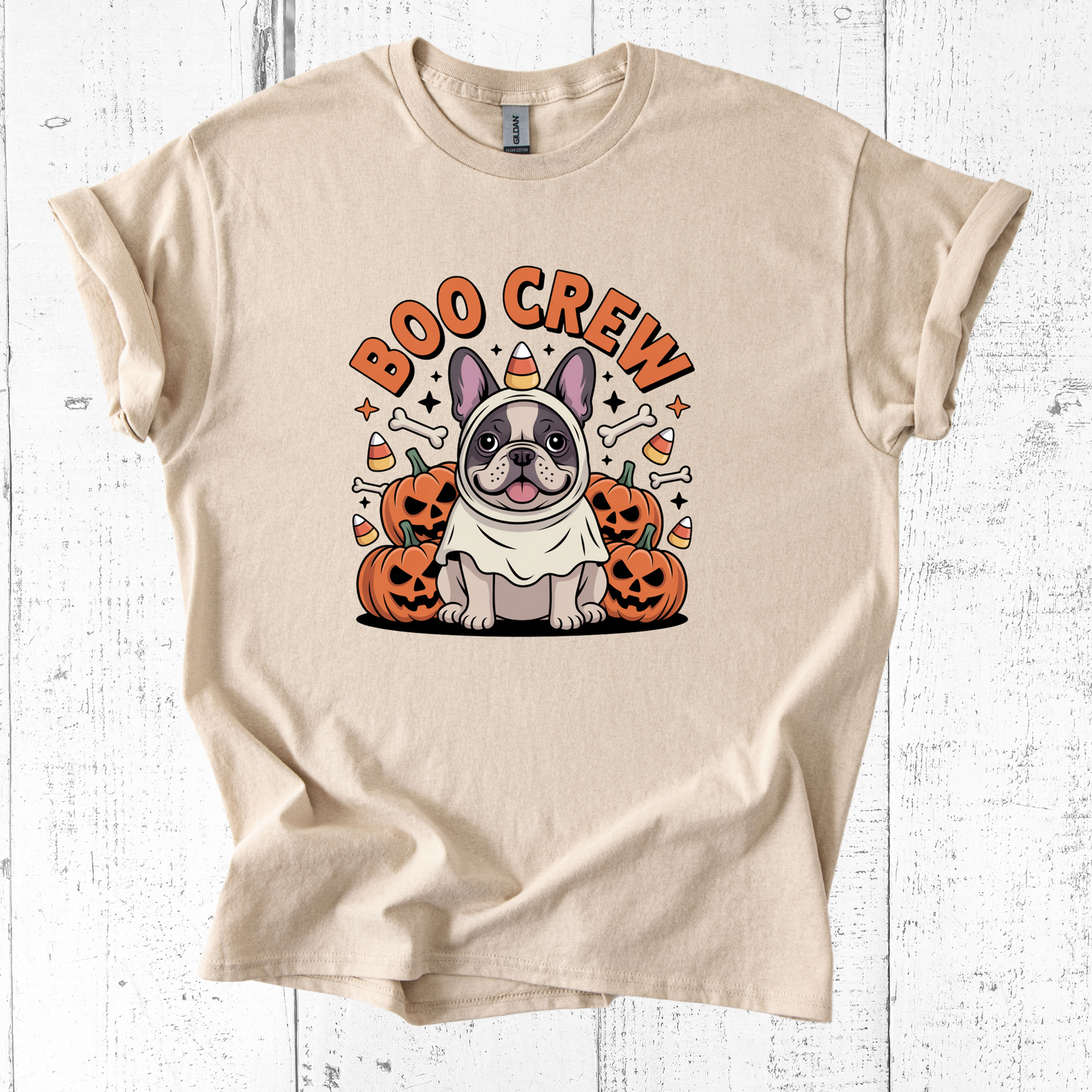 Beige t-shirt with a dog graphic and 'Boo Crew' text on a white wooden background