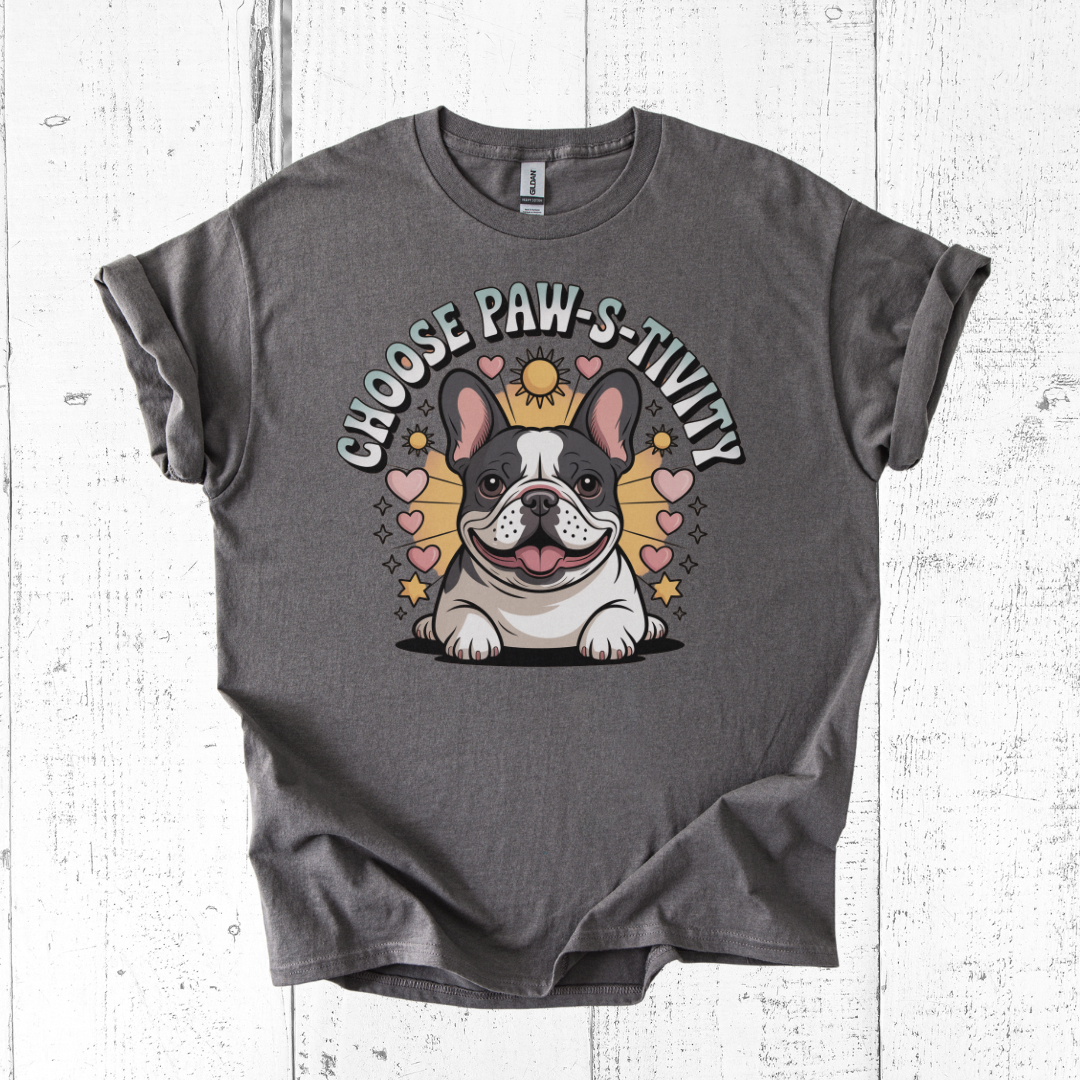 Gray t-shirt with a bulldog graphic and 'Choose PAW-sitivity' text on a wooden surface