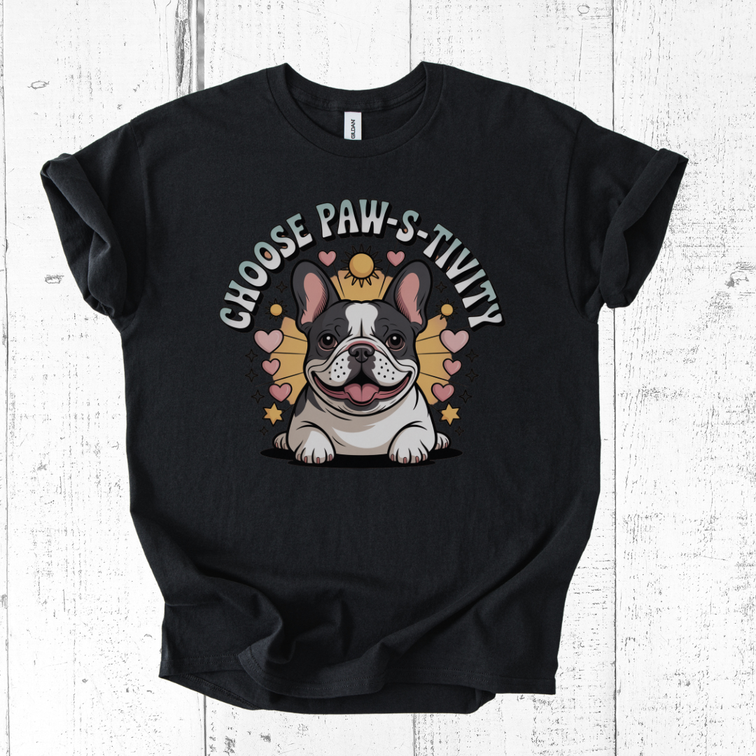 Black t-shirt with a dog graphic and text 'CHOOSE PAW-S-TIVITY' on a wooden surface