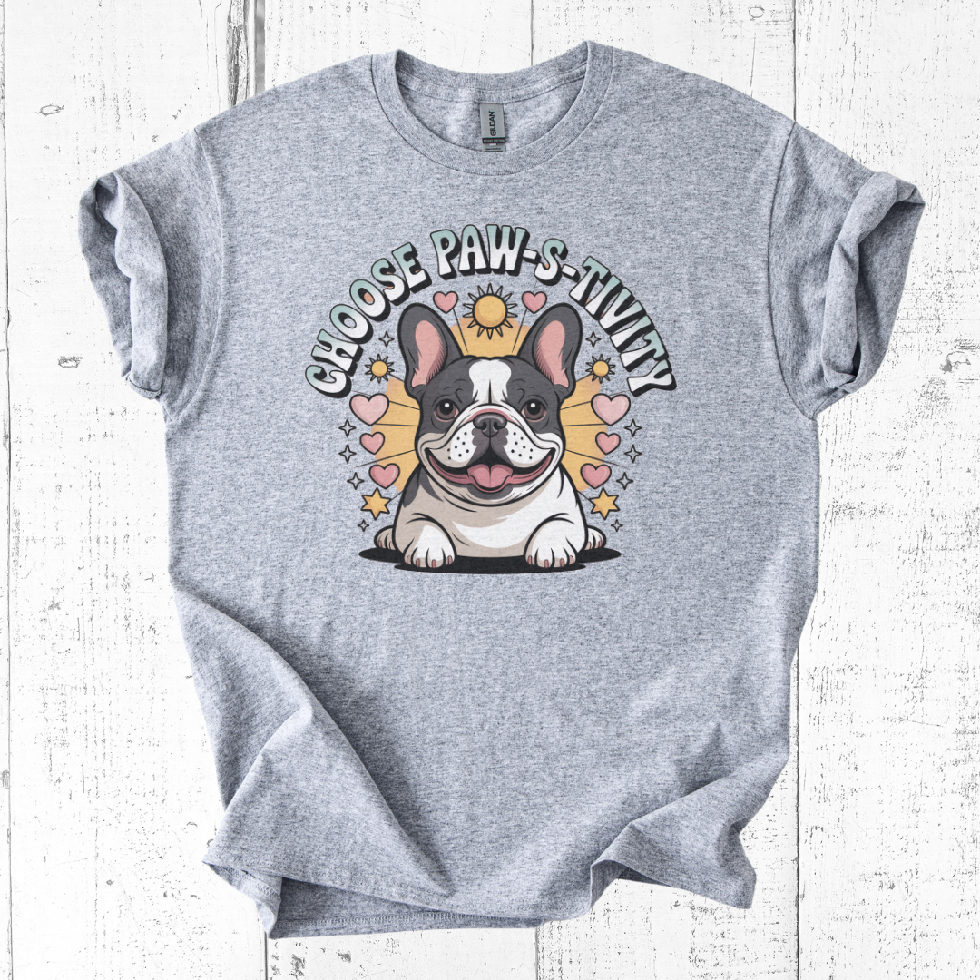 Gray t-shirt with a cartoon dog and 'Choose PAW-sitivity' text on a white wooden background