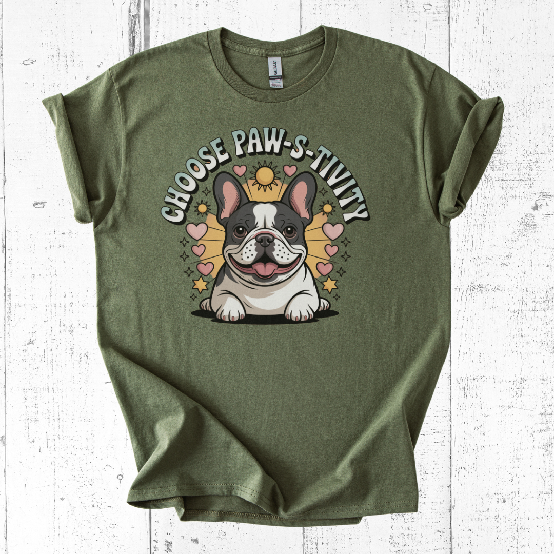 Green t-shirt with a dog graphic and text 'Choose Paw-s-tivity' on a white wooden surface