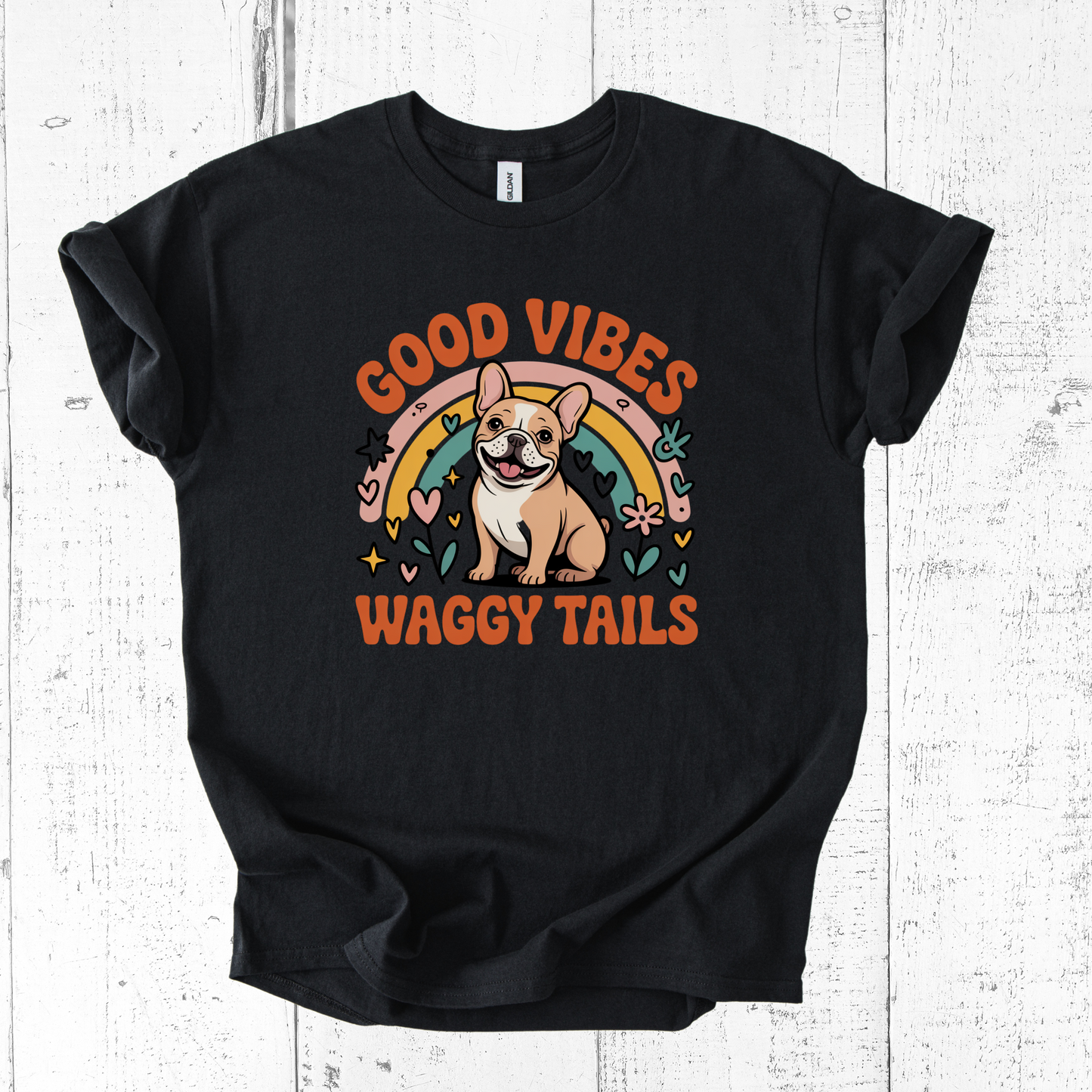Black t-shirt with a dog graphic and 'Good Vibes Waggy Tails' text on a white wooden background