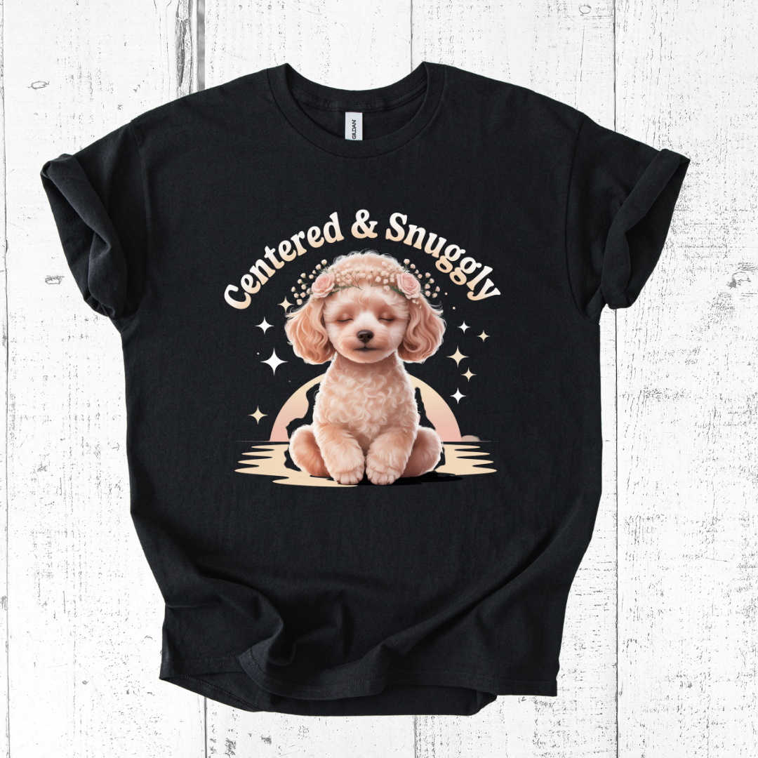 Black t-shirt with a graphic of a dog and text 'Centered & Snuggly' on a wooden surface