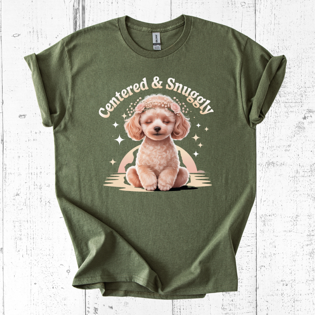 Green t-shirt with a cute dog graphic and 'Centered & Snuggly' text on a white wooden background