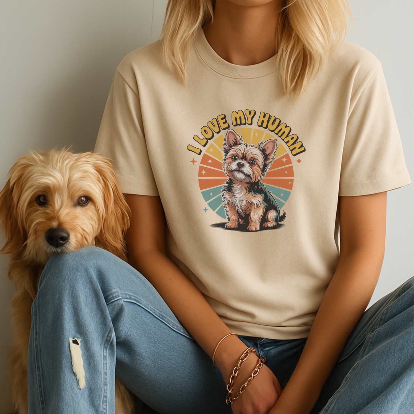Person wearing a t-shirt with a dog graphic and 'I Love My Human' text, sitting next to a small dog.