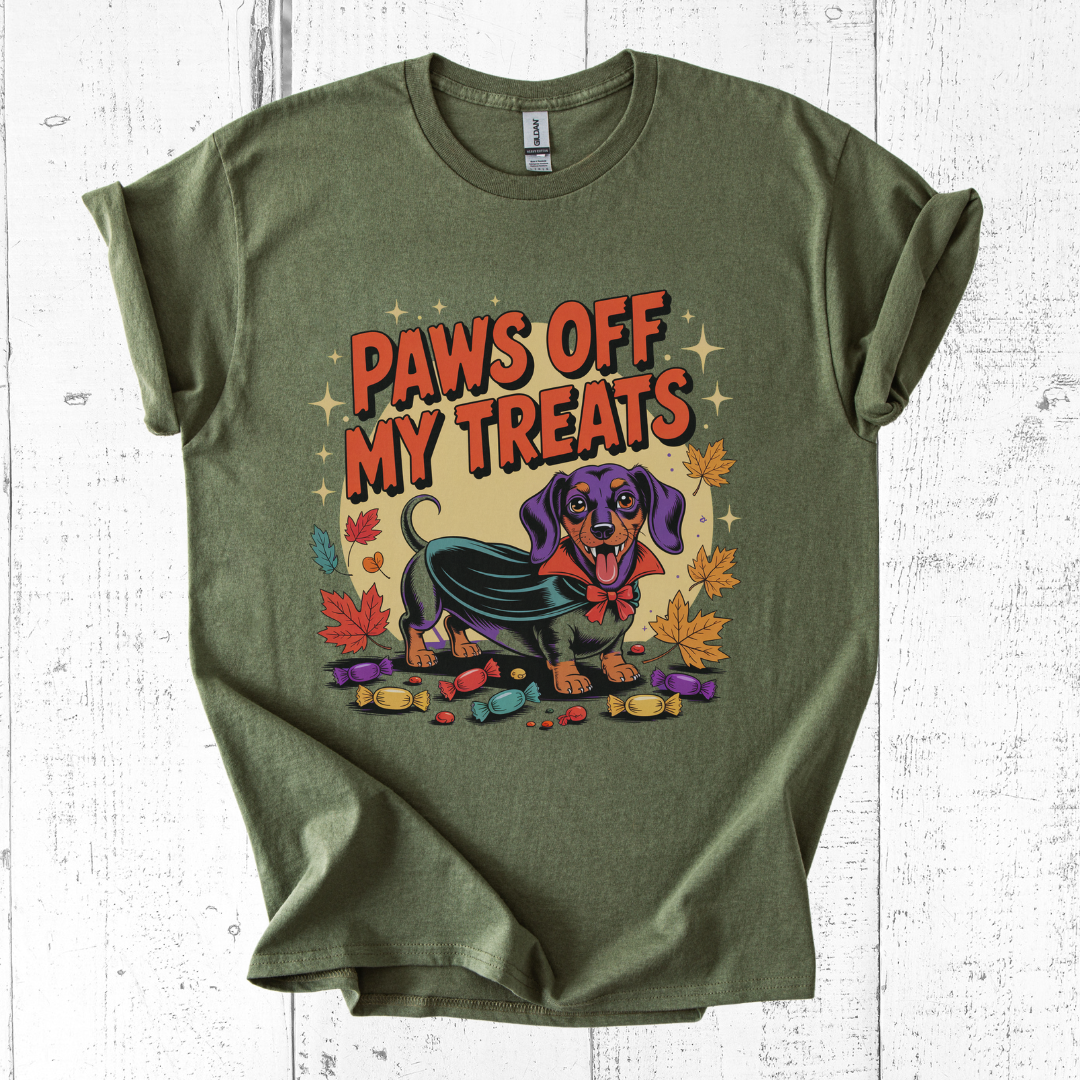 Green t-shirt with a graphic of a dog and text 'Paws Off My Treats' on a white wooden background