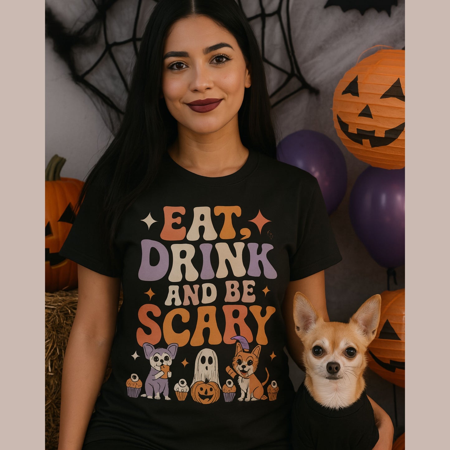 Woman wearing a Halloween-themed t-shirt with a dog in front of a decorated Halloween background.