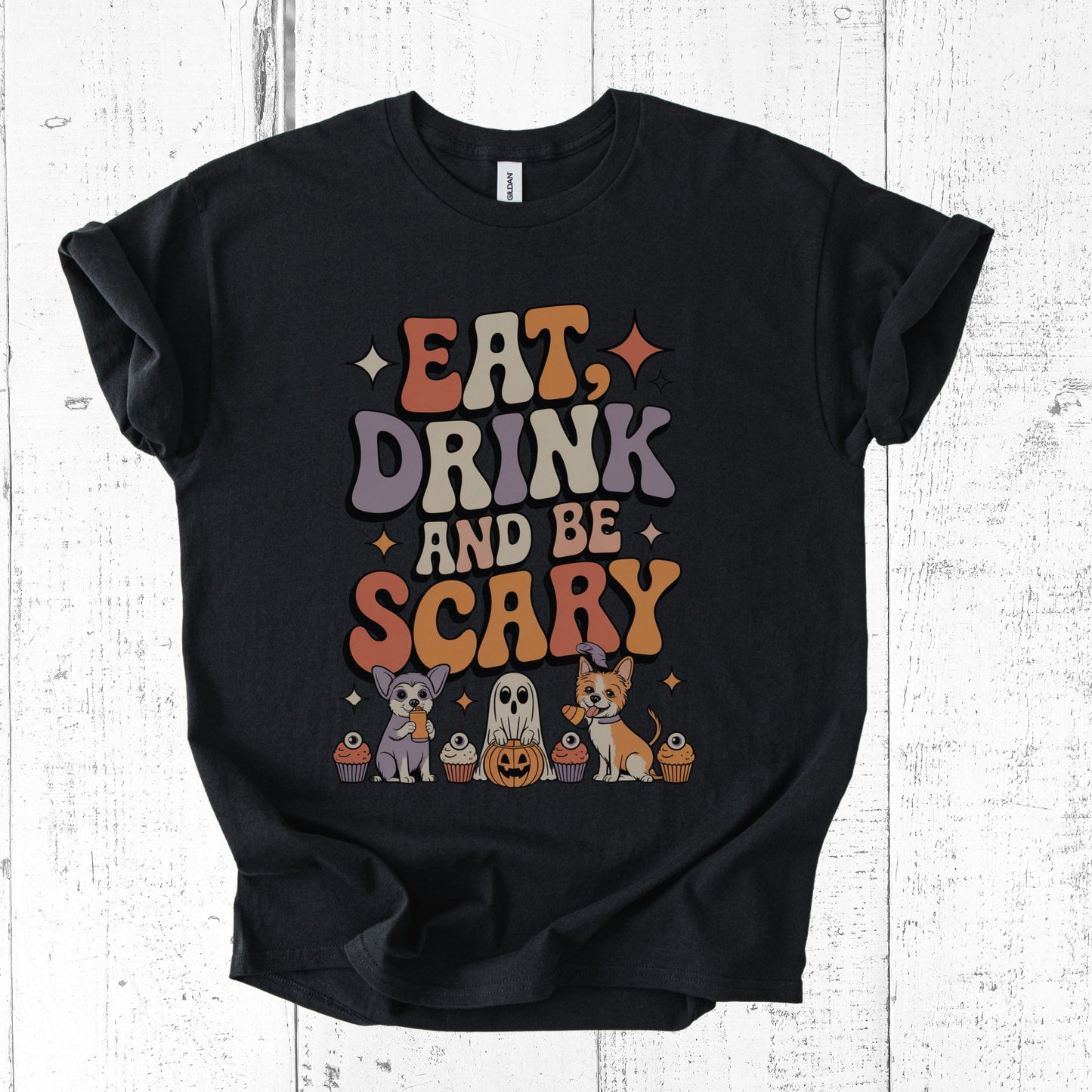 Black t-shirt with Halloween-themed design on a white wooden background