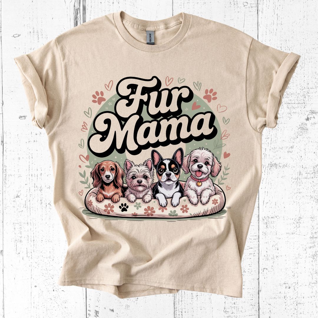 Beige t-shirt with 'Fur Mama' graphic featuring cartoon dogs on a white wooden background