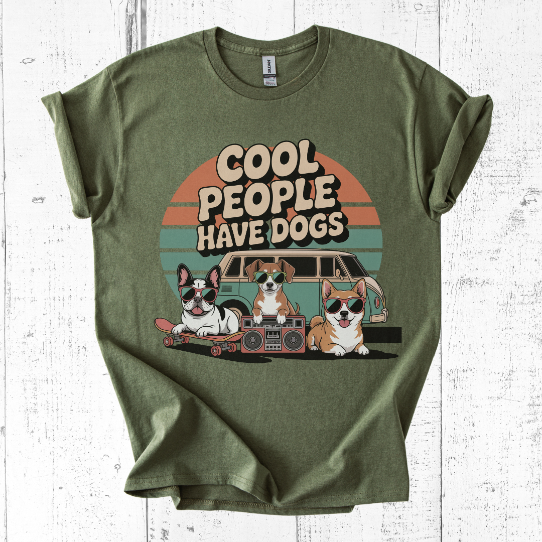 Green t-shirt with 'Cool people have dogs' graphic on a white wooden background