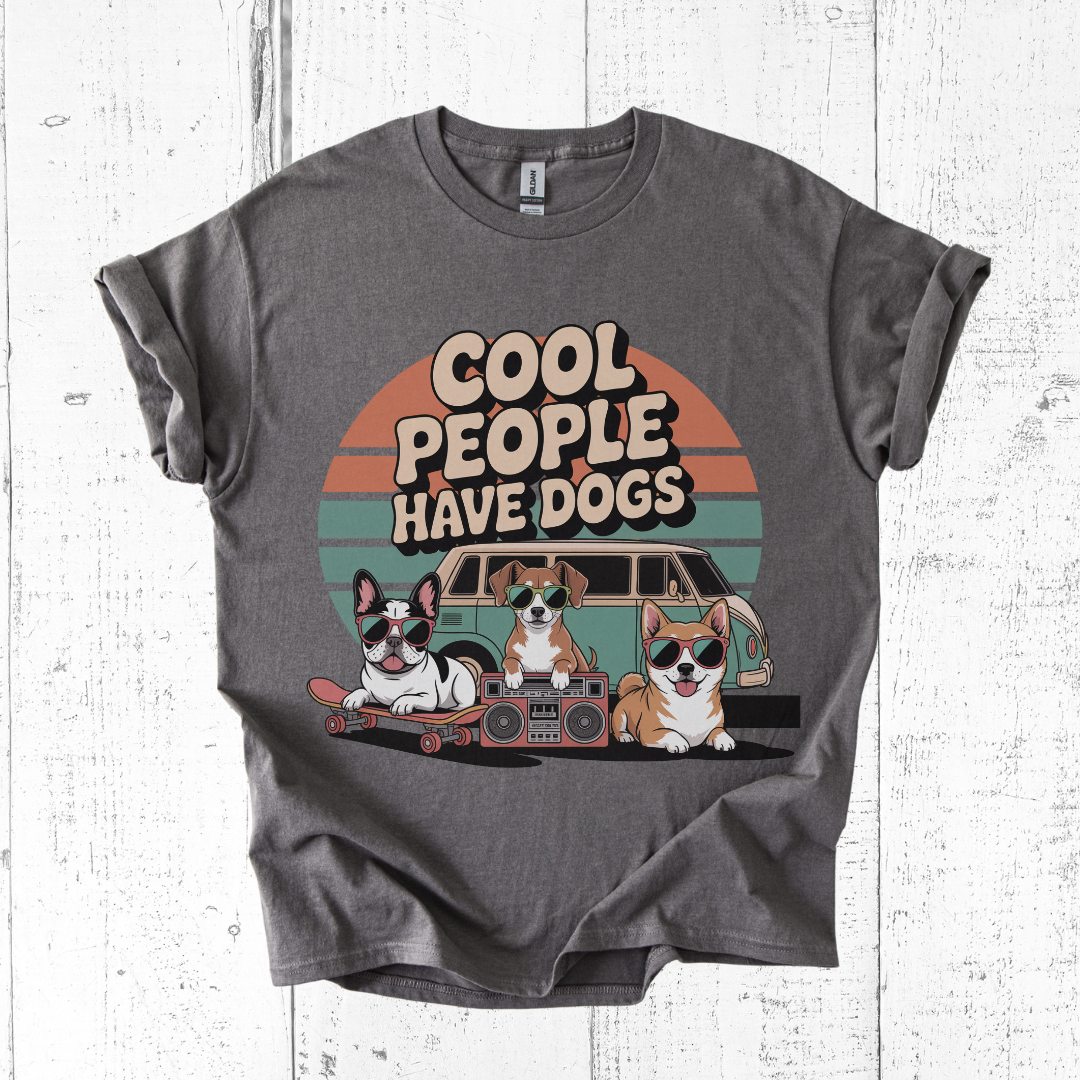 Gray t-shirt with 'Cool people have dogs' graphic on a white wooden background