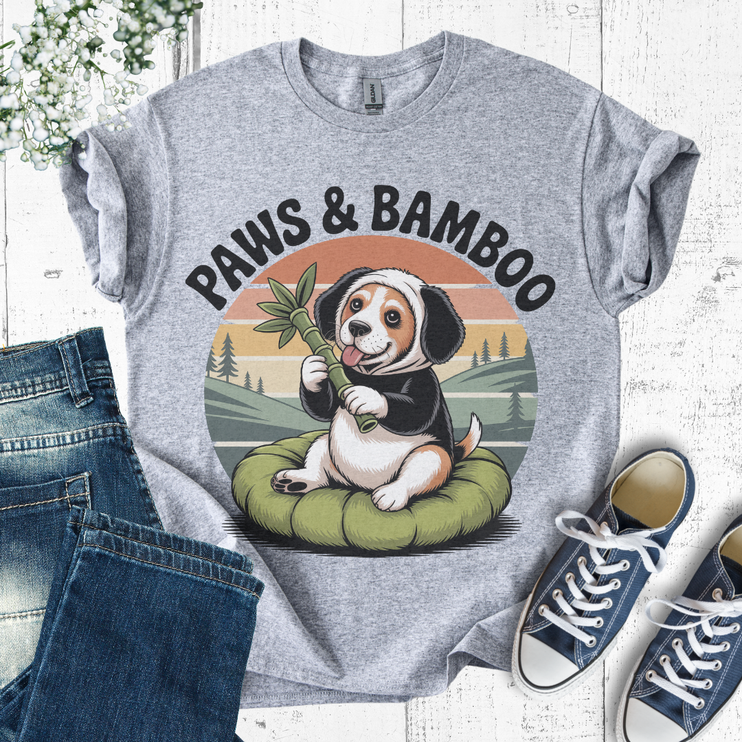 Gray t-shirt with a dog holding a bamboo stick graphic and 'Paws & Bamboo' text, displayed with jeans and sneakers.