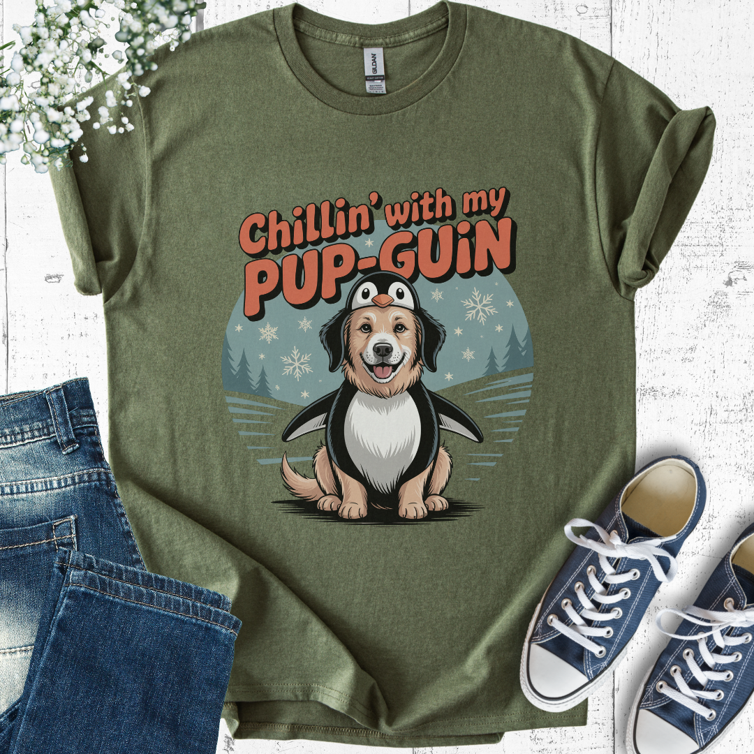 Green t-shirt with a cartoon penguin and dog hybrid character and text 'Chillin' with my PUP-GUIN', displayed with jeans and sneakers.