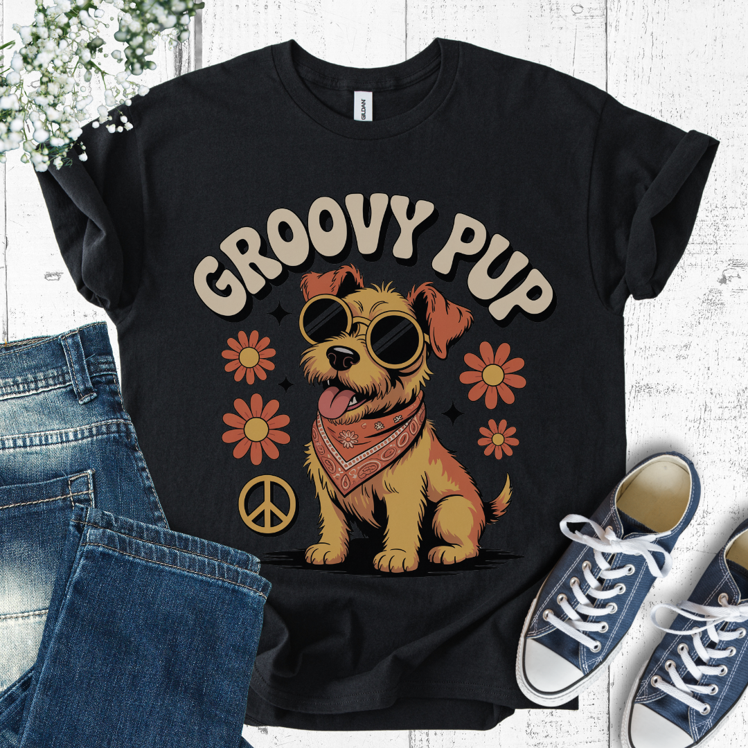 Black t-shirt with 'Groovy Pup' design featuring a dog, flowers, and peace signs, displayed with jeans and sneakers.