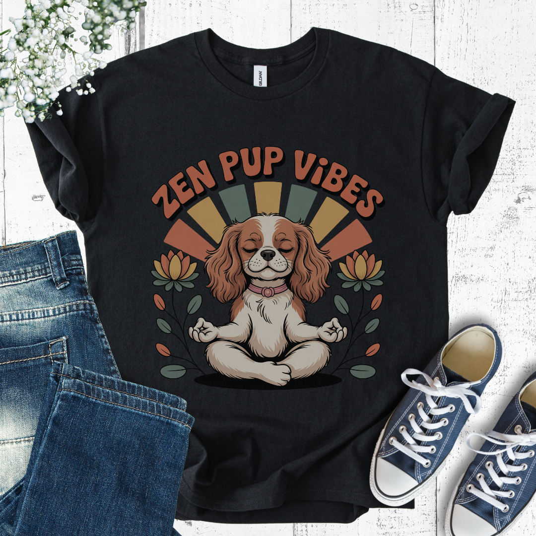Black t-shirt with 'Zen Pup Vibes' design featuring a dog in a meditative pose, placed on a white surface with jeans and sneakers.