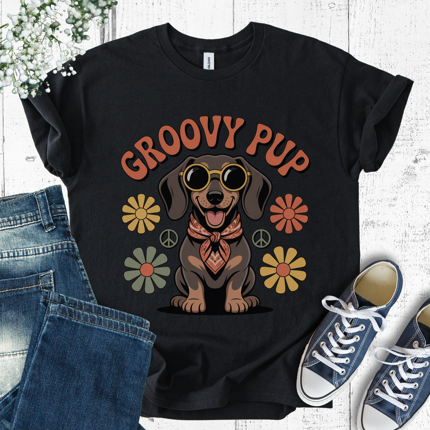 Black t-shirt with 'Groovy Pup' design featuring a dachshund, flowers, and peace signs on a white background.