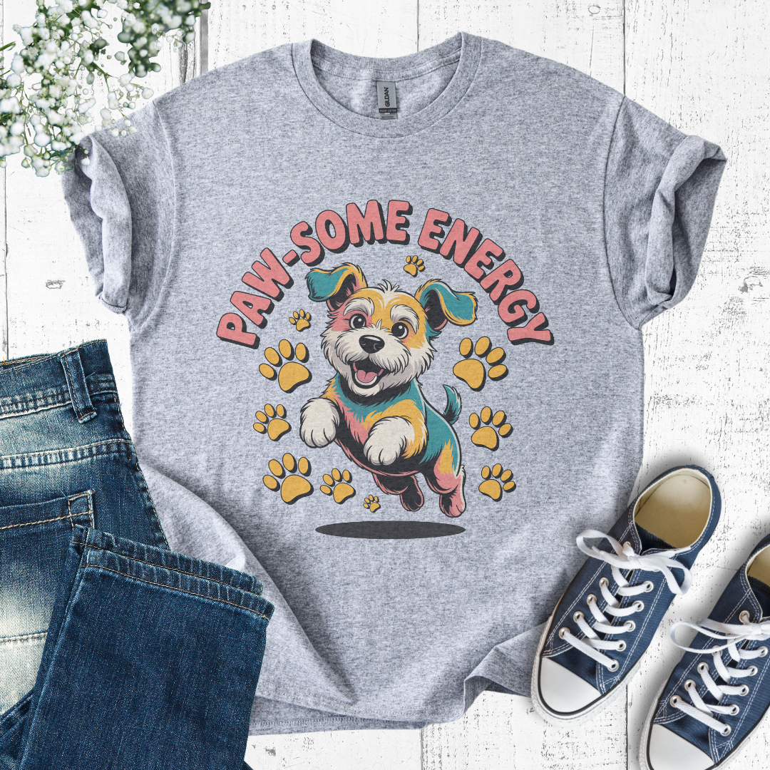 Gray t-shirt with a dog graphic and 'PAW-SOME ENERGY' text, paired with jeans and sneakers on a light wooden surface.