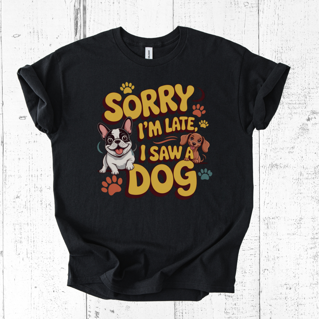 Black t-shirt with colorful graphic and text 'Sorry I'm late, I saw a dog' on a white wooden background