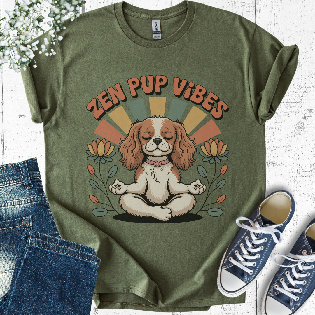 Green t-shirt with 'Zen Pup Vibes' design featuring a dog in a meditative pose, paired with jeans and sneakers on a light wooden surface.