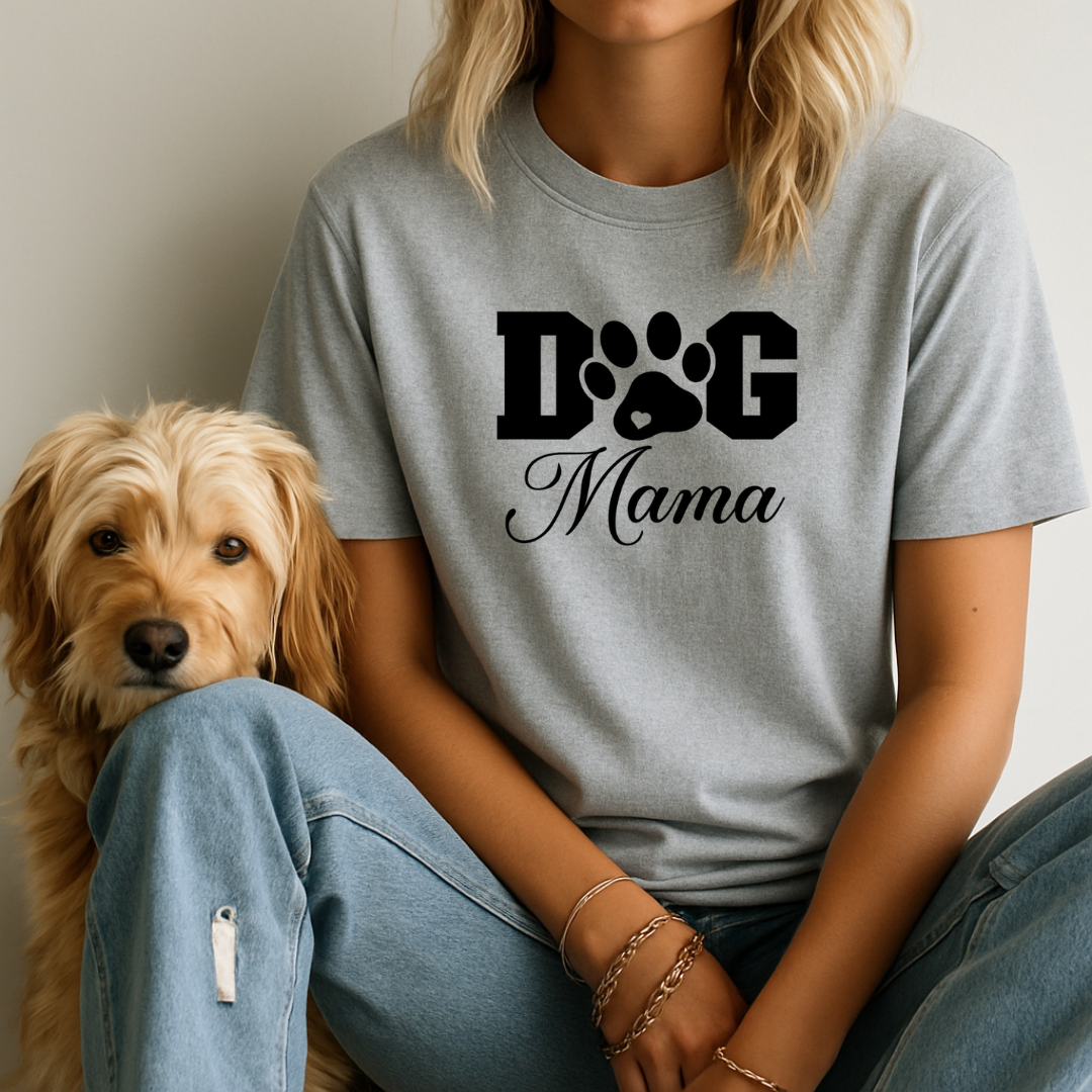 Person wearing a gray 'Dog Mama' t-shirt sitting next to a dog.