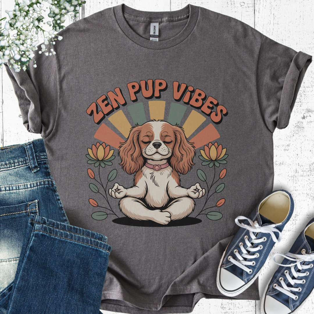 Gray t-shirt with 'Zen Pup Vibes' design featuring a dog in a meditative pose, paired with jeans and sneakers on a light wooden surface.