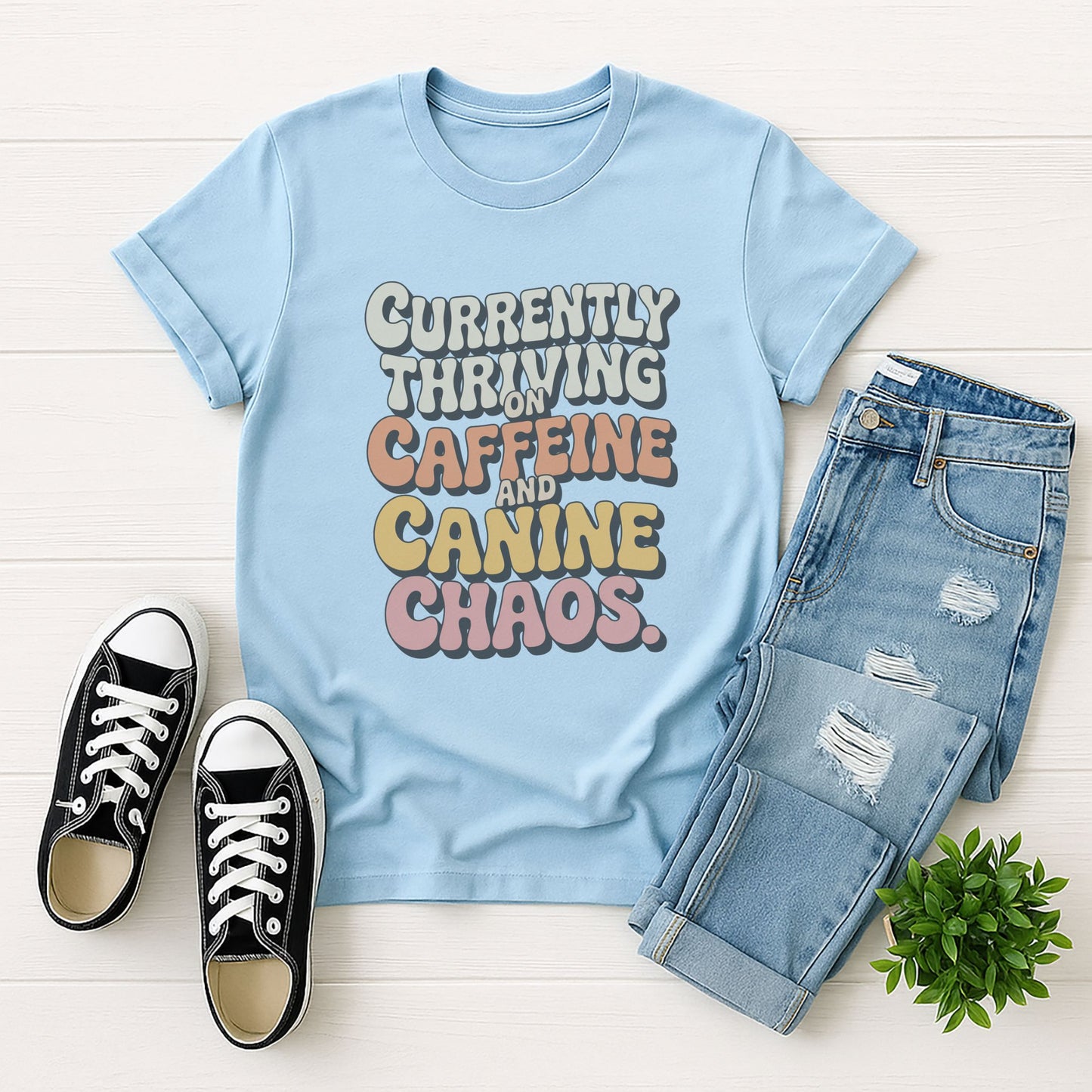 Light Blue Gildan 6400 unisex t-shirt with retro dog graphic and âCurrently Thriving On Caffeine And Canine Chaosâ text, perfect for dog lovers.