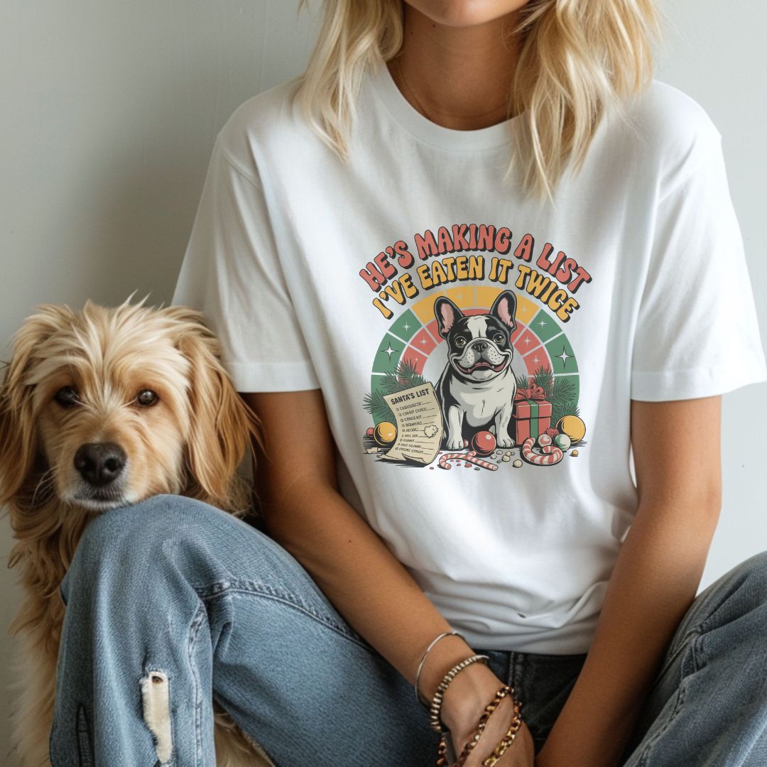 White unisex t-shirt with retro dog graphic and ‘He's Making A List I've Eaten It Twice' text, perfect for dog lovers.