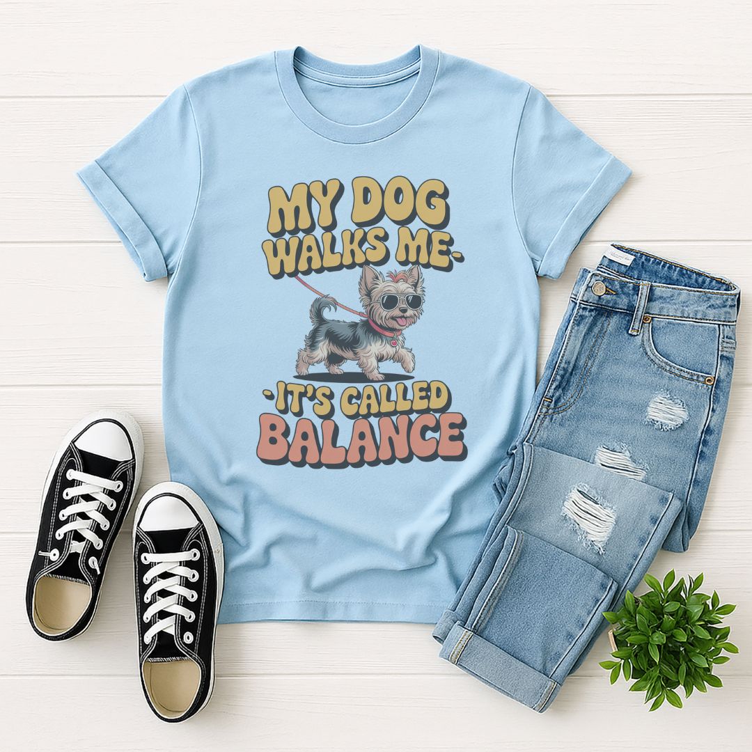 Light blue Gildan 6400 unisex t-shirt with retro dog graphic and ‘My Dog Walk Me - It's Called Balance' text, perfect for dog lovers.