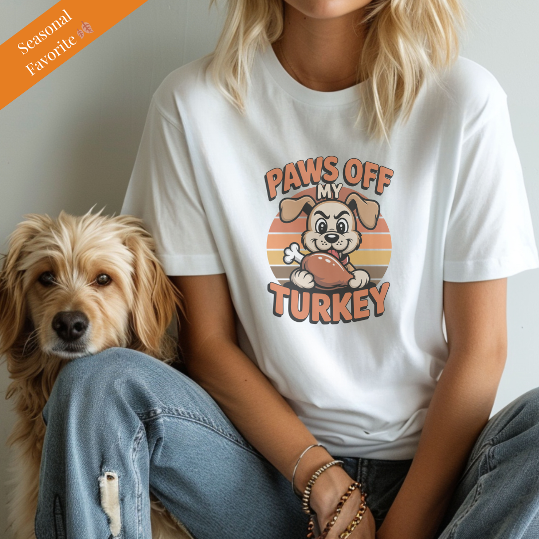 White unisex t-shirt with retro dog graphic and ‘Paws Off My Turkey’ text, perfect for dog lovers.