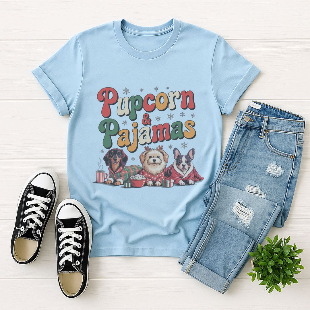 Light blue Gildan 6400 unisex t-shirt with retro dog graphic and ‘Pupcorn & Pajamas' text, perfect for dog lovers.