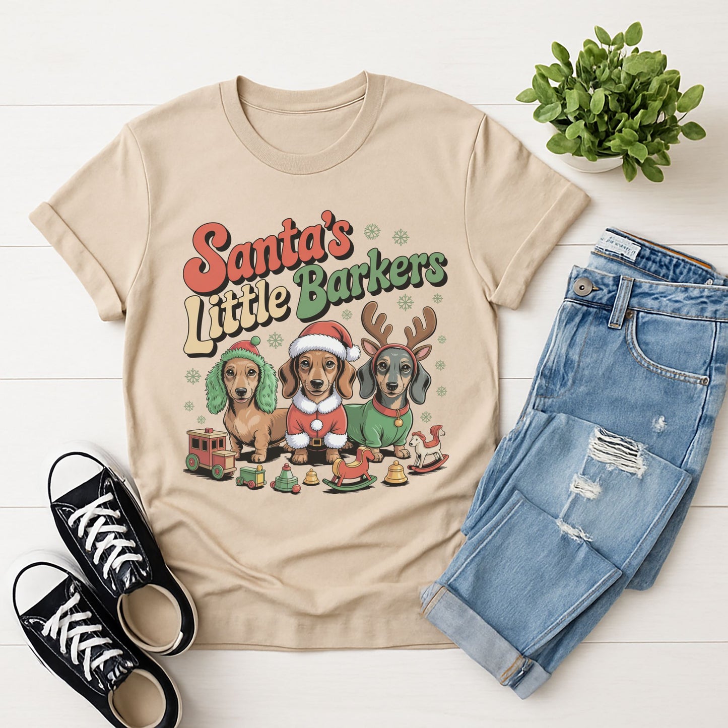 Sand Beige Gildan 6400 unisex t-shirt with retro dog graphic and ‘Santa's Little Barkers' text, perfect for dog lovers.
