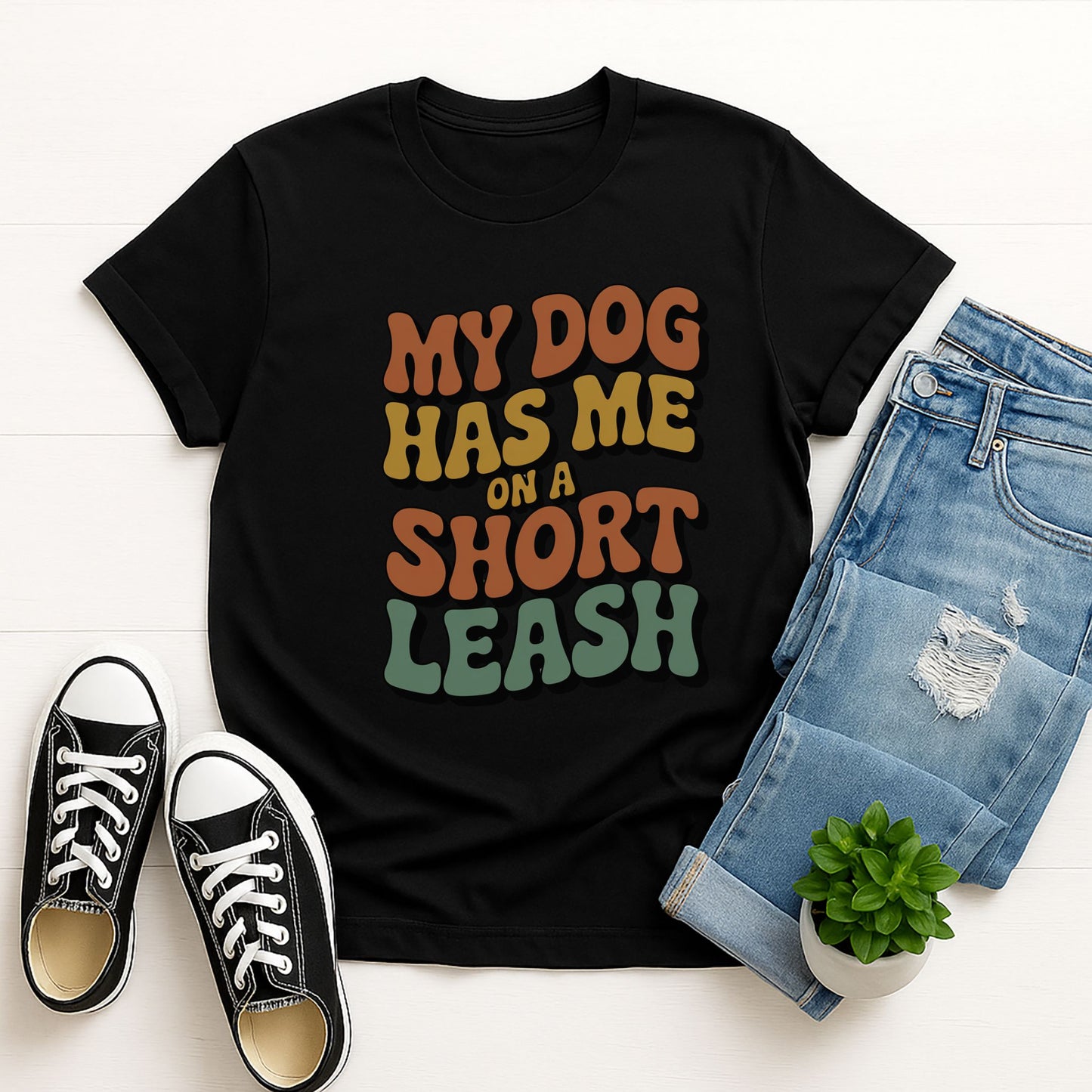 Black Gildan 6400 unisex t-shirt with retro dog graphic and ‘My Dog Has Me On A Short Leash’ text, perfect for dog lovers.