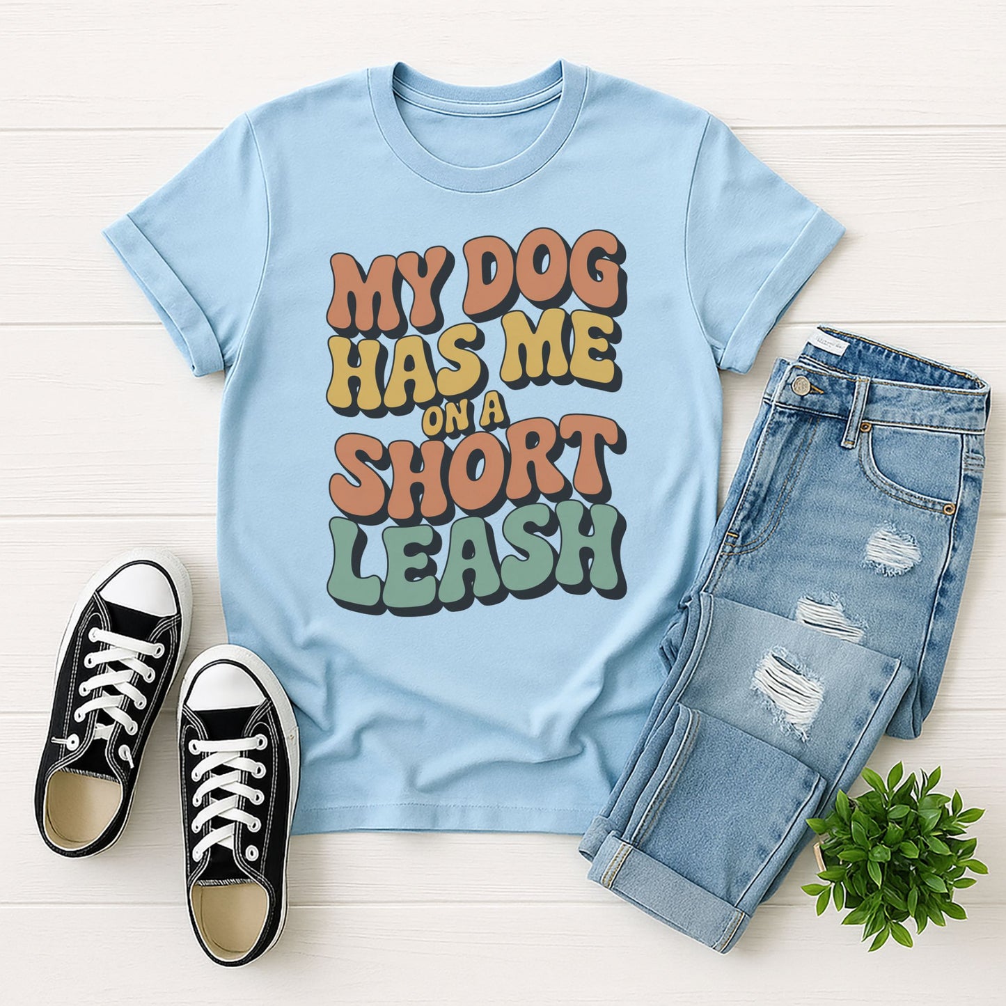 Light Blue Gildan 6400 unisex t-shirt with retro dog graphic and ‘My Dog Has Me On A Short Leash’ text, perfect for dog lovers.