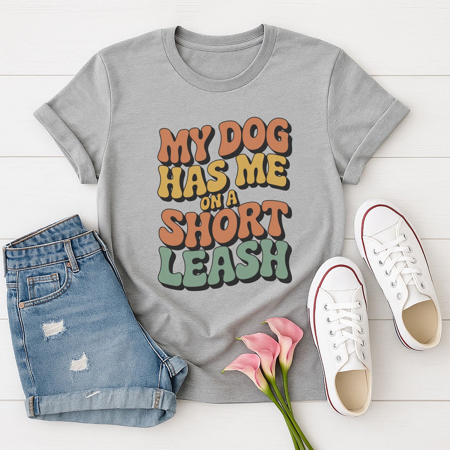 Sport Gray Gildan 6400 unisex t-shirt with retro dog graphic and ‘My Dog Has Me On A Short Leash’ text, perfect for dog lovers.