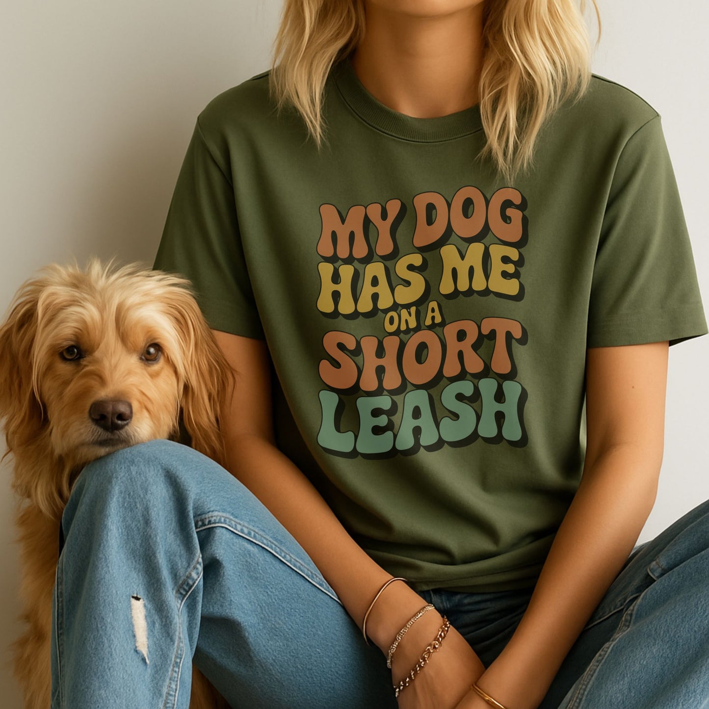 Military Green Gildan 6400 unisex t-shirt with retro dog graphic and ‘My Dog Has Me On A Short Leash’ text, perfect for dog lovers.