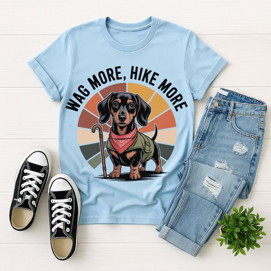 Light blue Gildan 6400 unisex t-shirt with retro dog graphic and ‘Wag More, Hike More.’ text, perfect for dog lovers.