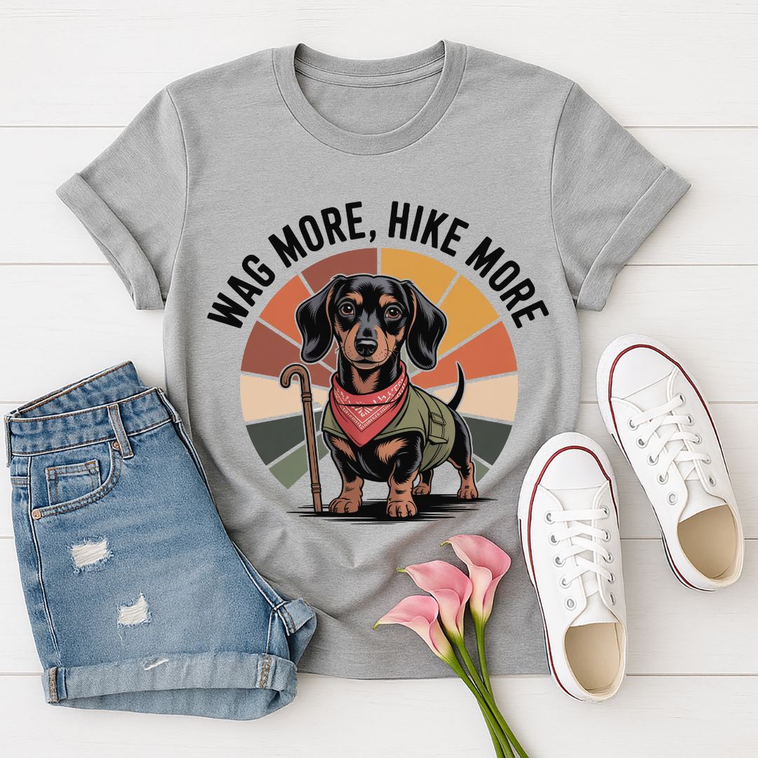 Sport Gray Gildan 6400 unisex t-shirt with retro dog graphic and ‘Wag More, Hike More.’ text, perfect for dog lovers.